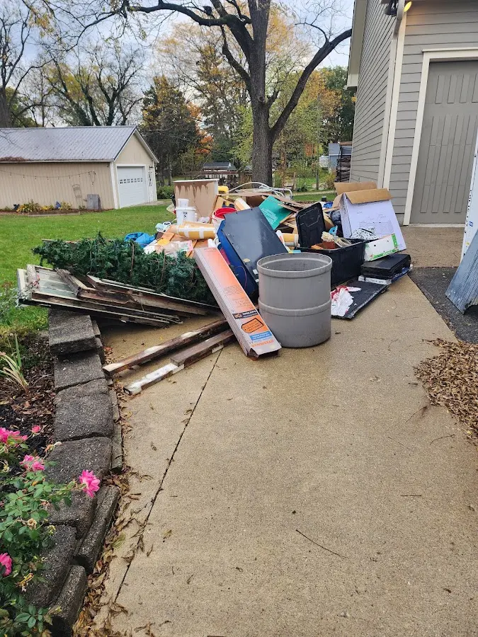 Dumpster being loaded with debris for Roofing Dumpster Rental in Muldrow